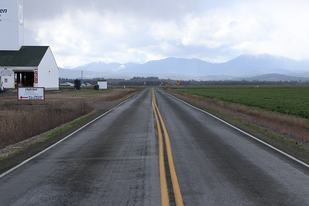 A long shot of a rural roadway. 