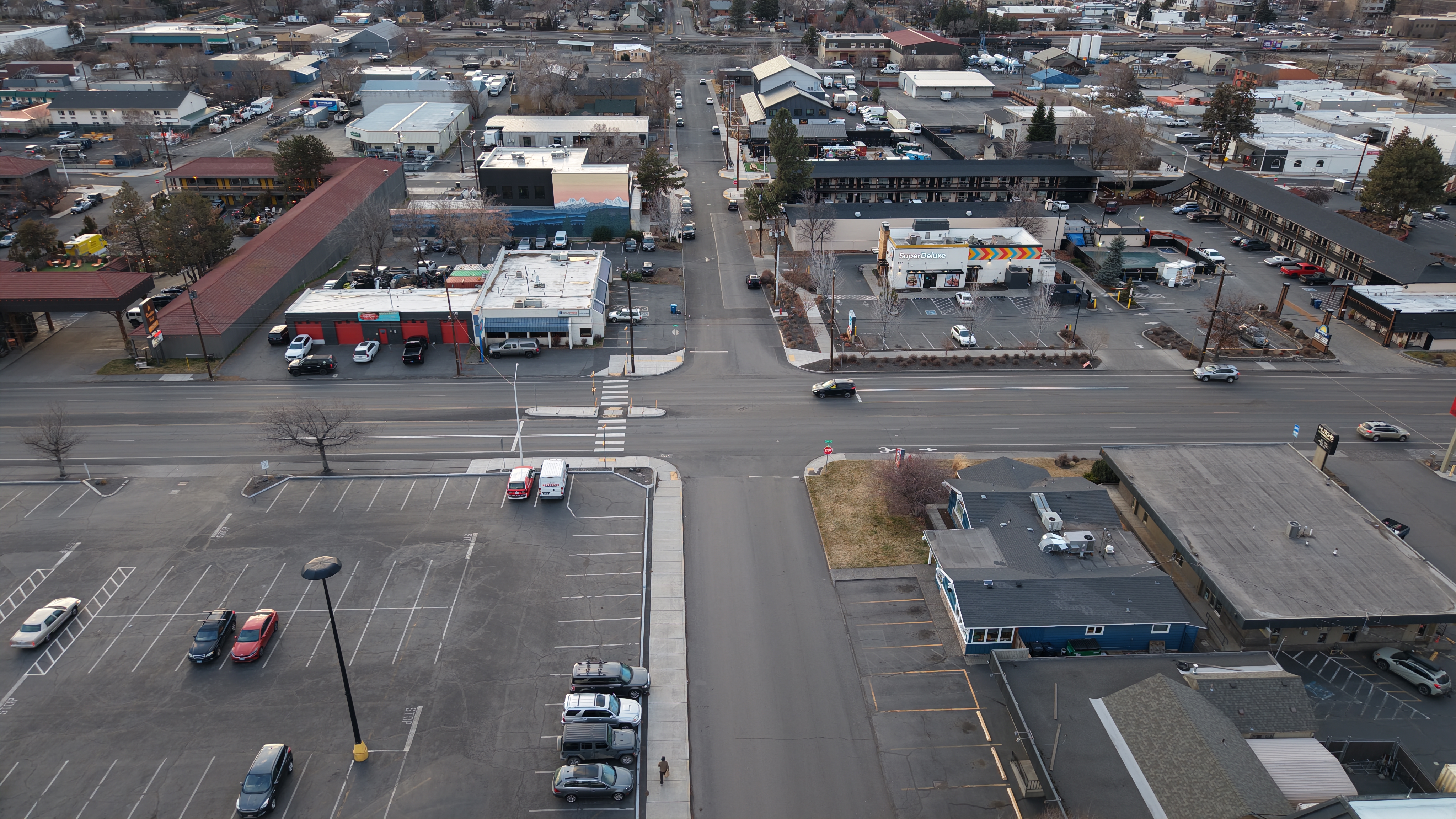Aerial view of Hawthorne Avenue showing a wide commercial street with large parking areas, scattered buildings, and limited pedestrian or cycling infrastructure.